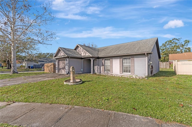 ranch-style home featuring a front yard and a garage