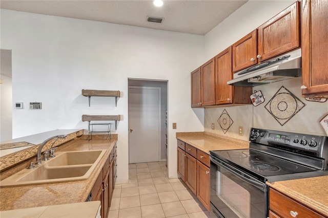 kitchen featuring black electric range oven, light tile patterned floors, and sink