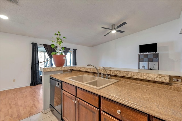 kitchen with dishwasher, a textured ceiling, ceiling fan, and sink