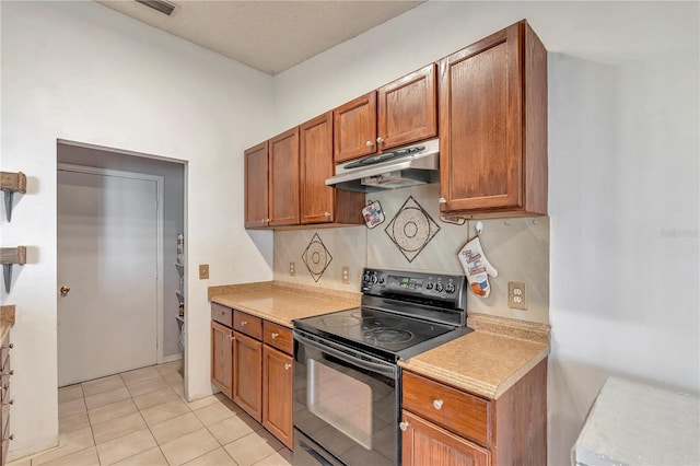 kitchen featuring black electric range oven and light tile patterned flooring