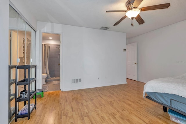 bedroom with connected bathroom, ceiling fan, a closet, and light wood-type flooring