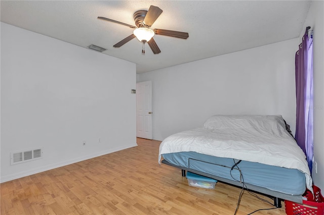 bedroom with ceiling fan and light wood-type flooring