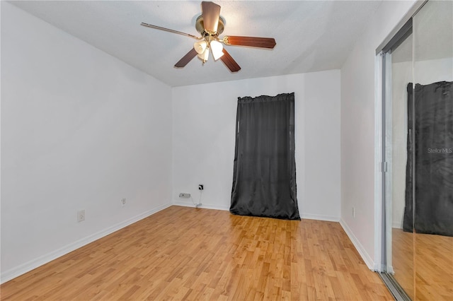 empty room featuring ceiling fan, a textured ceiling, and light hardwood / wood-style flooring