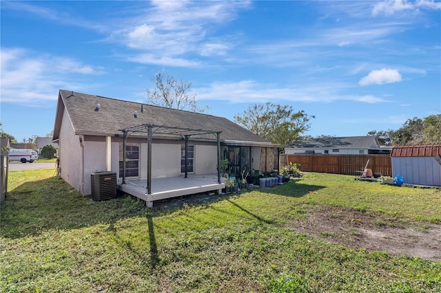 back of property with a pergola, a yard, cooling unit, and a deck