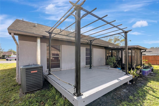 deck featuring central AC unit and a lawn