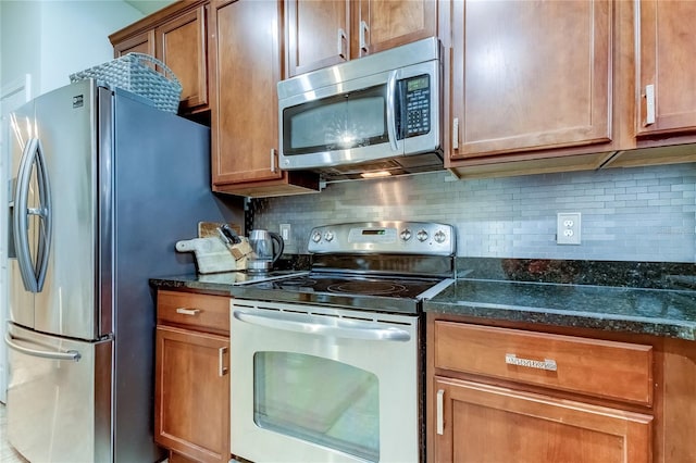 kitchen with dark stone countertops, decorative backsplash, and appliances with stainless steel finishes