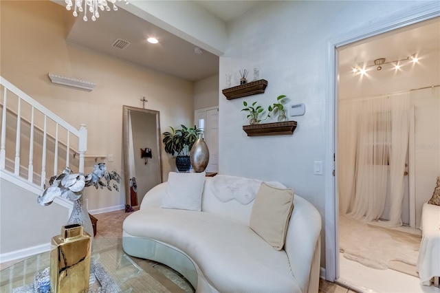 living room with tile patterned flooring and a chandelier