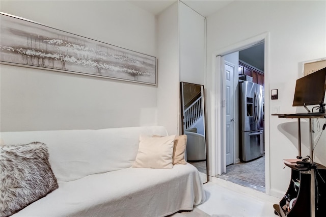 bedroom with stainless steel fridge with ice dispenser