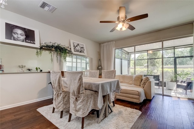 dining area with ceiling fan and dark hardwood / wood-style floors