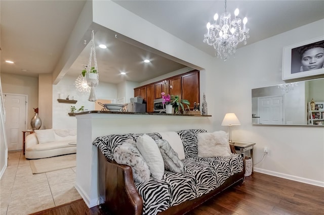 living room featuring light hardwood / wood-style floors and a notable chandelier