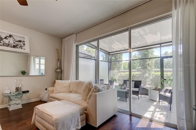 living room with dark wood-type flooring and a wealth of natural light