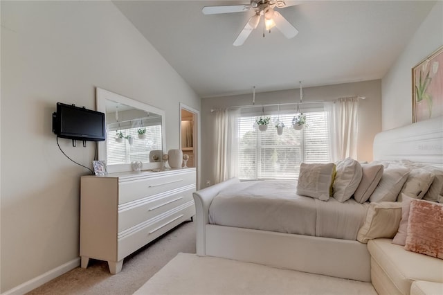 bedroom with ceiling fan, light colored carpet, and vaulted ceiling