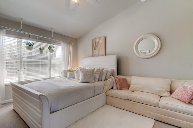 carpeted bedroom with ceiling fan and lofted ceiling