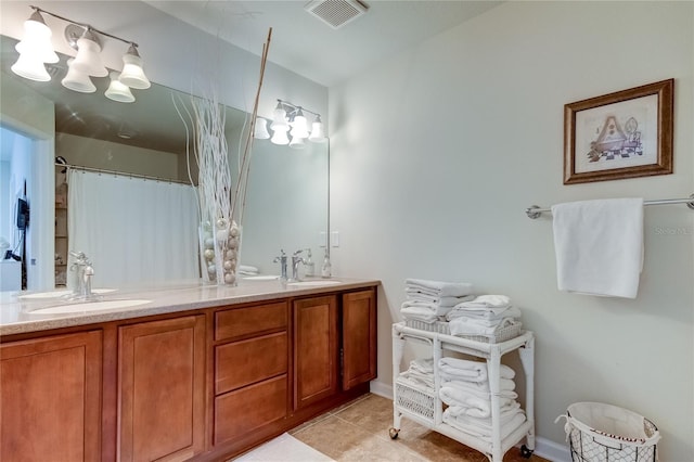 bathroom with a shower with curtain, vanity, and tile patterned floors