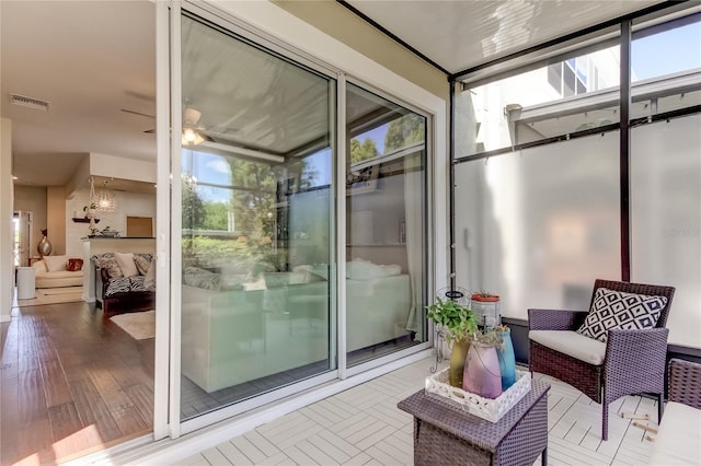 sunroom / solarium with ceiling fan