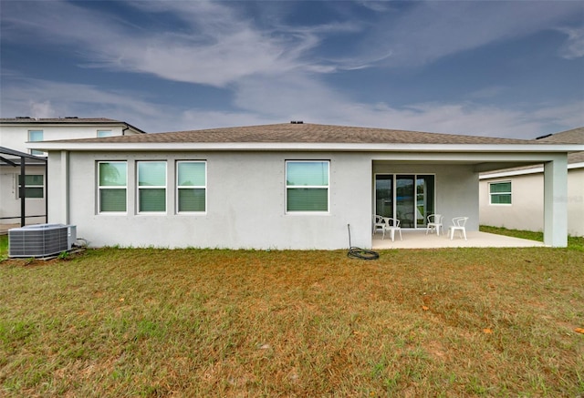 back of property featuring a lawn, a patio area, and central air condition unit