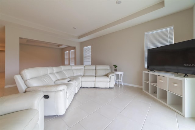 tiled living room with a raised ceiling