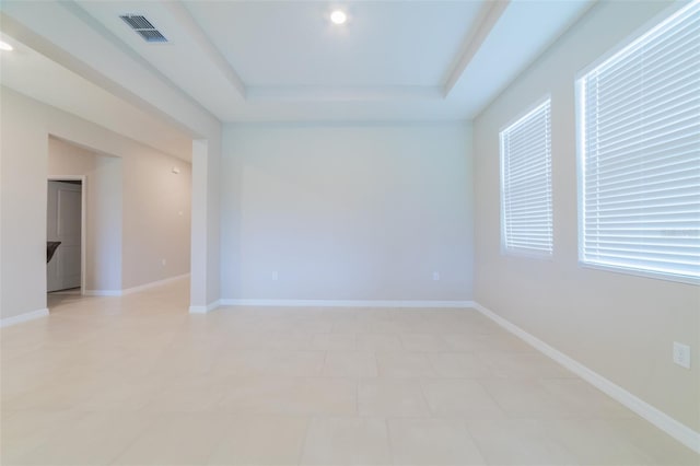 empty room featuring a tray ceiling