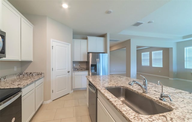 kitchen featuring light stone countertops, sink, white cabinetry, and stainless steel appliances