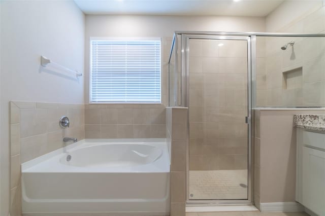 bathroom featuring tile patterned flooring, vanity, and independent shower and bath