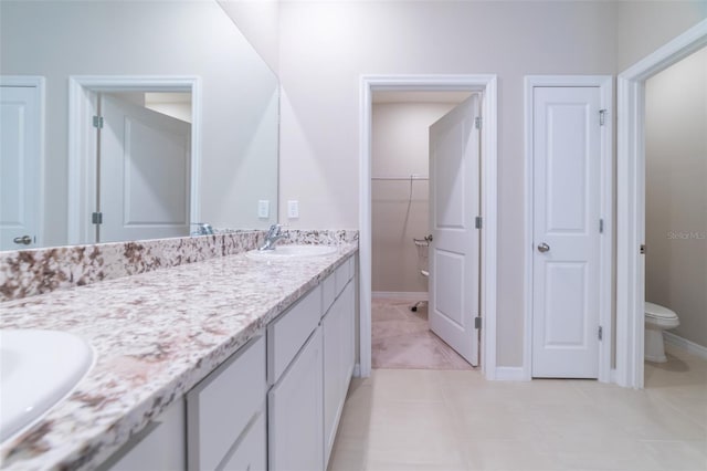 bathroom featuring tile patterned flooring, vanity, and toilet