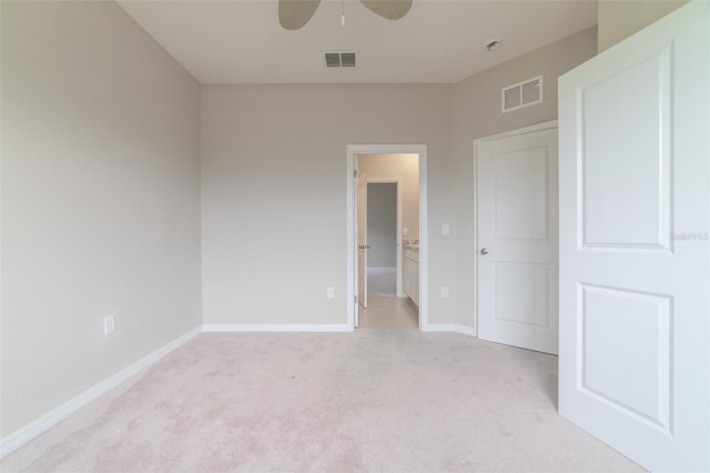 unfurnished bedroom featuring light carpet and ceiling fan