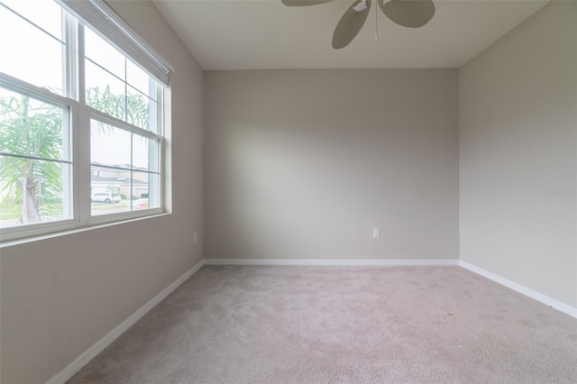 spare room featuring ceiling fan and light carpet