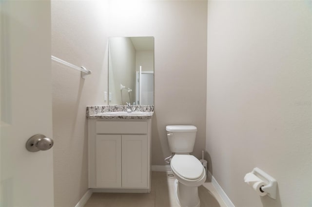 bathroom with tile patterned floors, vanity, and toilet