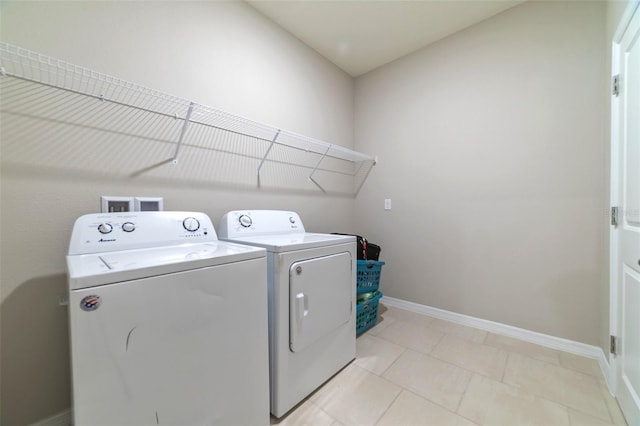 laundry room with light tile patterned floors and separate washer and dryer