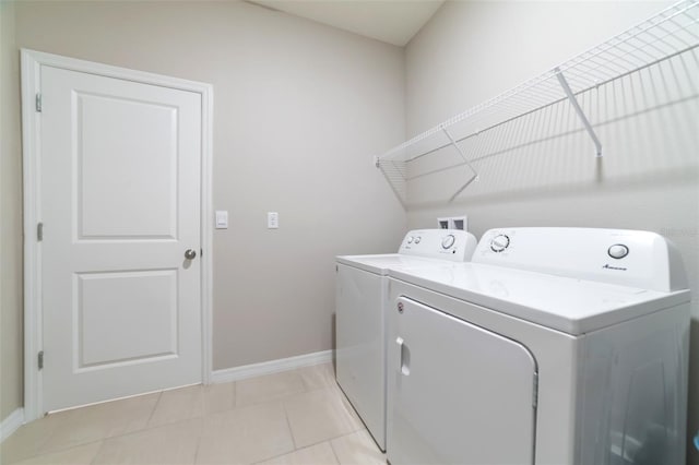 laundry room featuring independent washer and dryer and light tile patterned floors