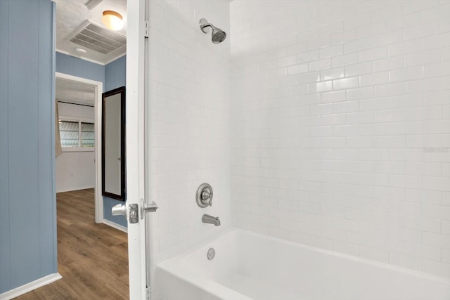 bathroom with wood-type flooring and shower / tub combination