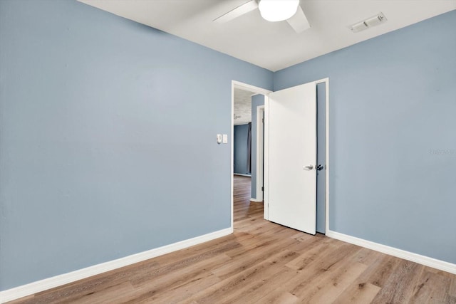 spare room featuring ceiling fan and light hardwood / wood-style floors