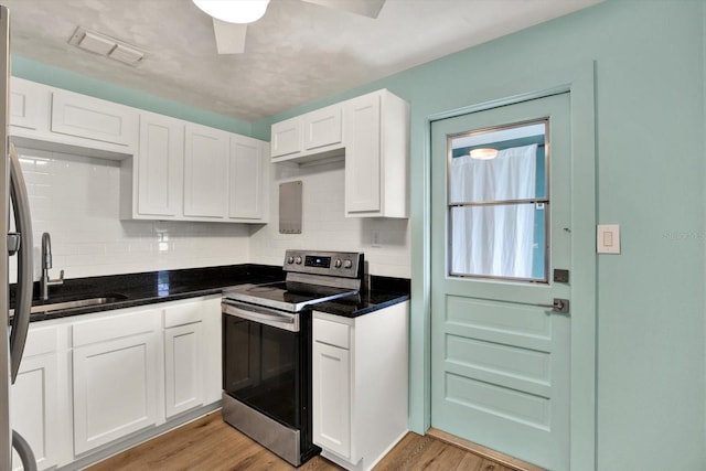 kitchen with white cabinetry, stainless steel electric range oven, and light wood-type flooring