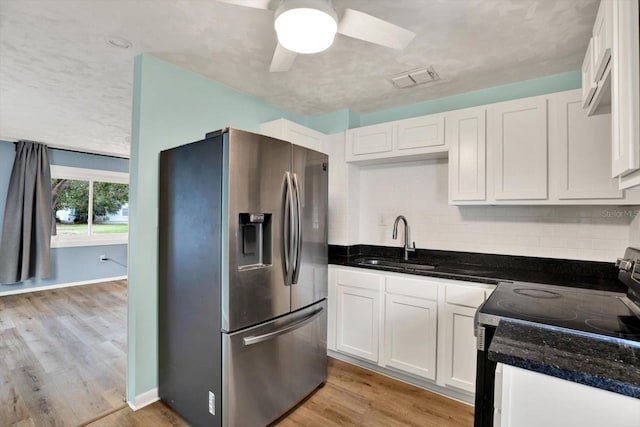 kitchen with white cabinets, sink, electric range, stainless steel fridge, and light wood-type flooring