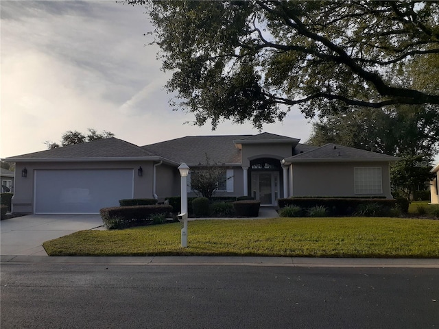 ranch-style home with a lawn and a garage