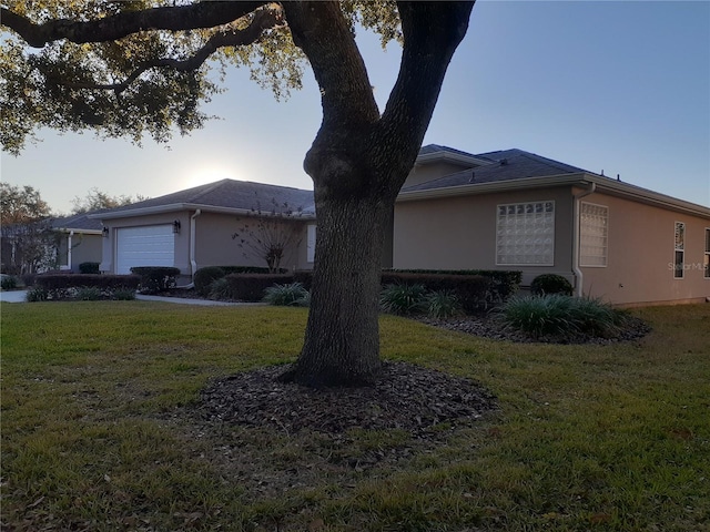 view of front of property with a garage and a front lawn