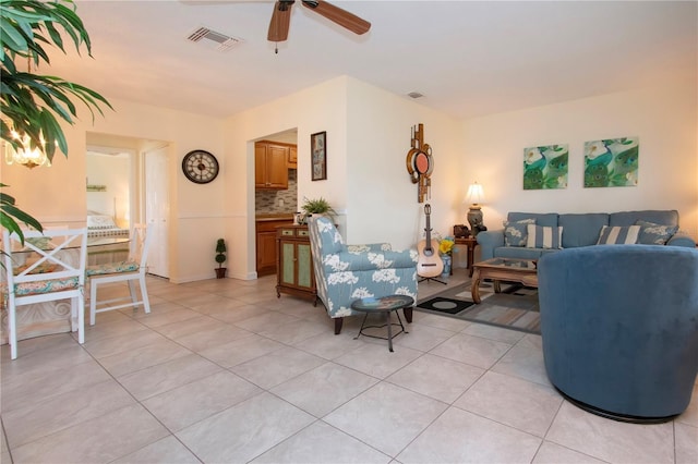 tiled living room with ceiling fan