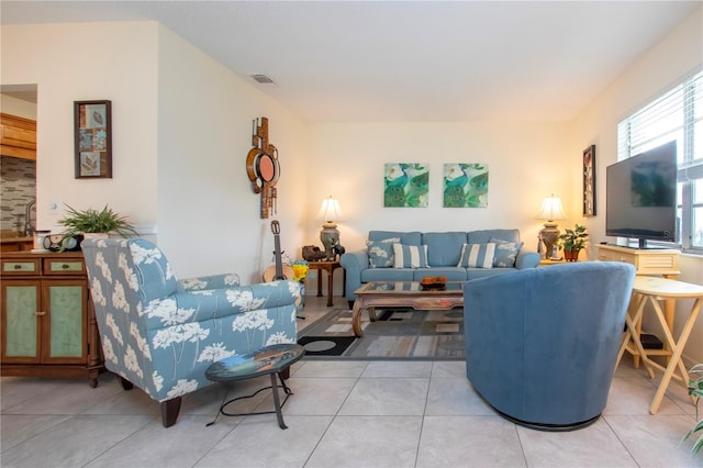 living room with light tile patterned floors and sink