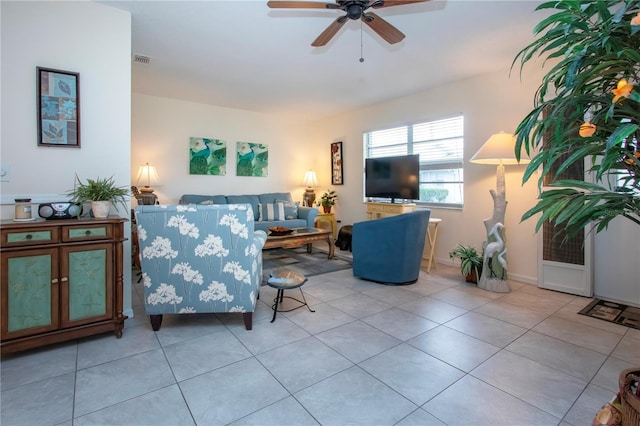 tiled living room featuring ceiling fan