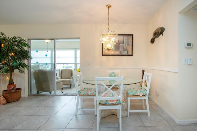 tiled dining area featuring a notable chandelier