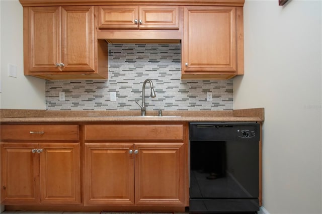 kitchen featuring sink, black dishwasher, and backsplash