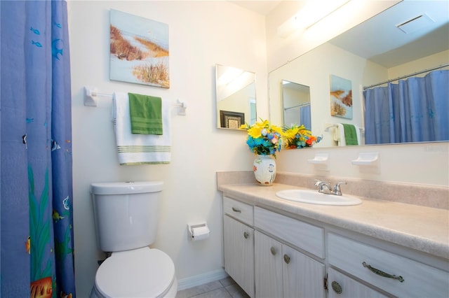 bathroom featuring tile patterned floors, vanity, and toilet