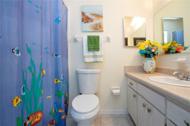 bathroom with tile patterned floors, curtained shower, vanity, and toilet