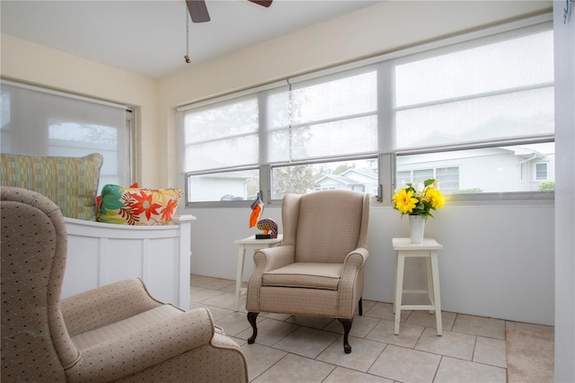 sitting room with light tile patterned floors and ceiling fan