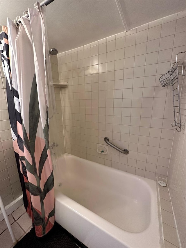 bathroom with tile patterned flooring and shower / bath combo with shower curtain