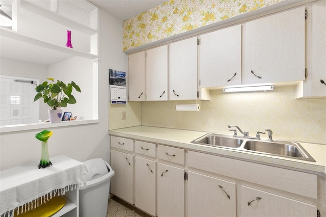 kitchen featuring sink and tasteful backsplash