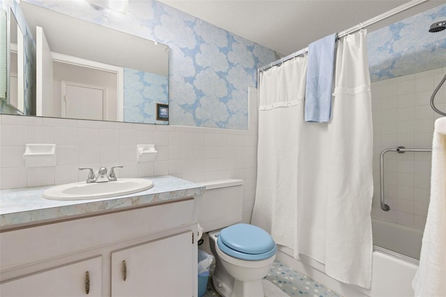 full bathroom featuring shower / bath combination with curtain, vanity, toilet, and tile walls