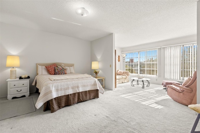 carpeted bedroom featuring a textured ceiling