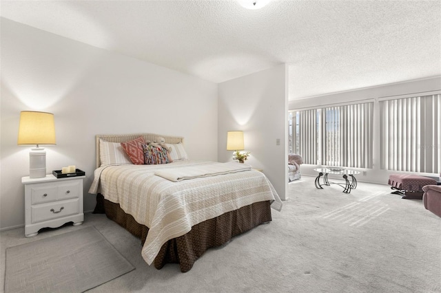 bedroom with light carpet and a textured ceiling