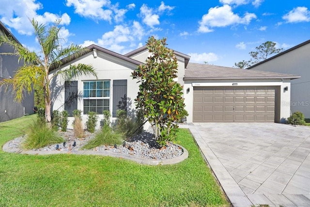 single story home with a garage and a front lawn